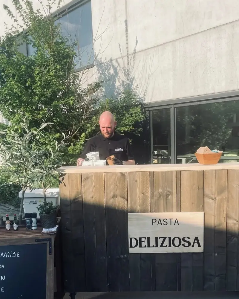 Kok achter de stijgerhouten bar op een event in Kortrijk